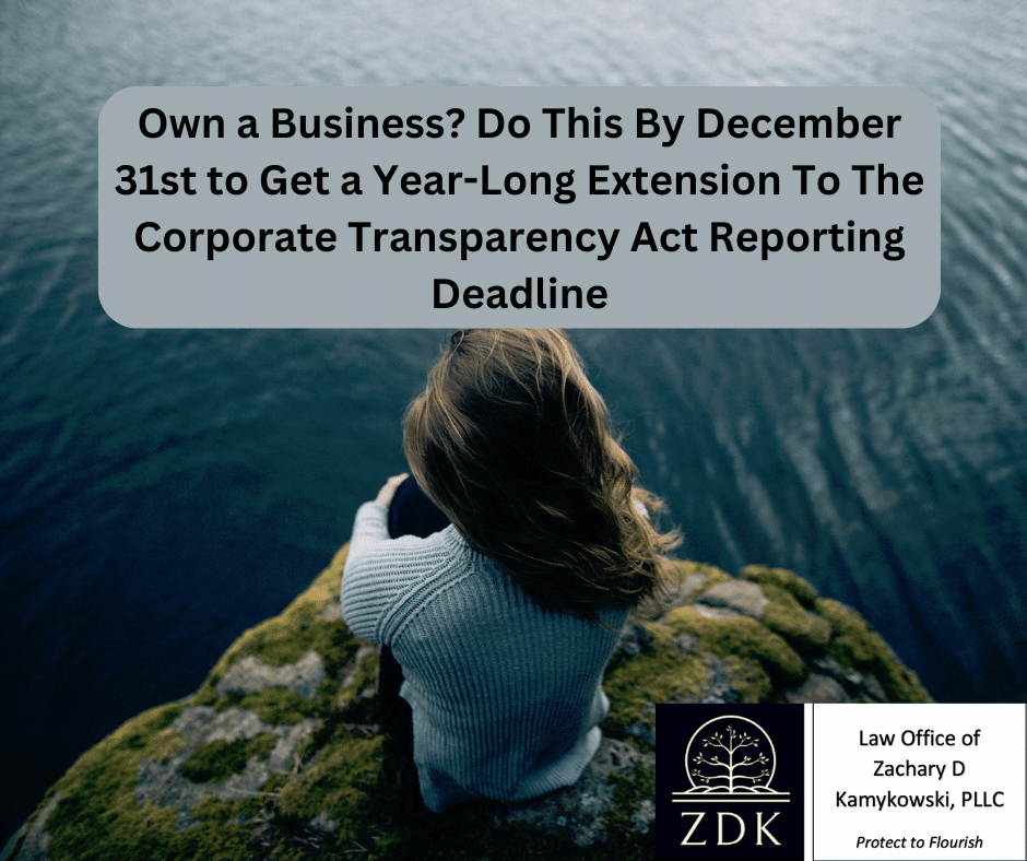 Woman sitting on a cliff: Own a Business Do This By December 31st to Get a Year-Long Extension To The Corporate Transparency Act Reporting Deadline